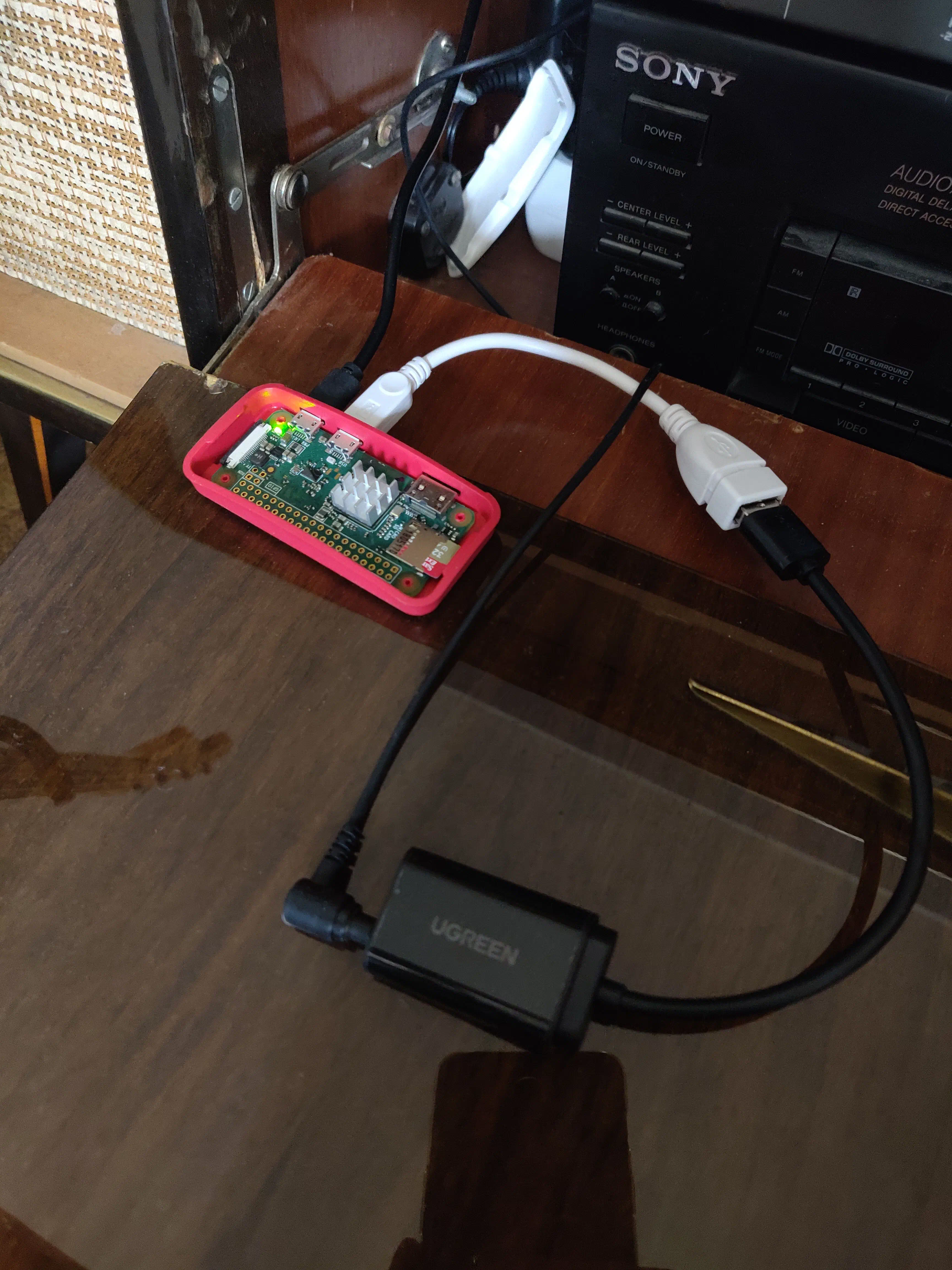 Raspberry Pi Zero W in its original case next to my amplifier with USB sound card